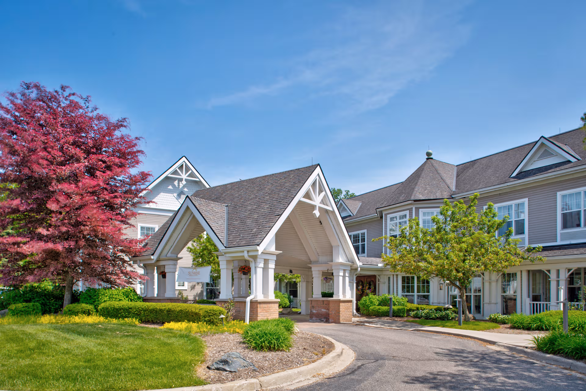 Sunrise of West Bloomfield exterior with a pitched entrance and landscaped grounds.
