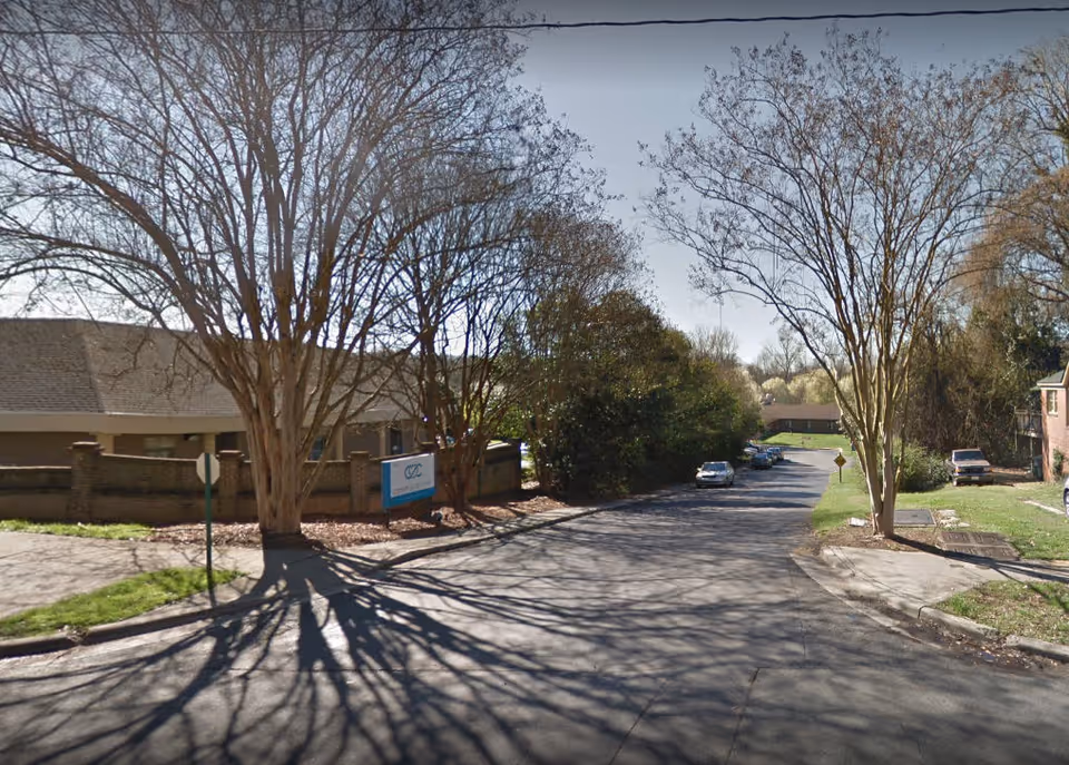 Street view of Peak Resources Charlotte exterior with bare trees and parked cars.