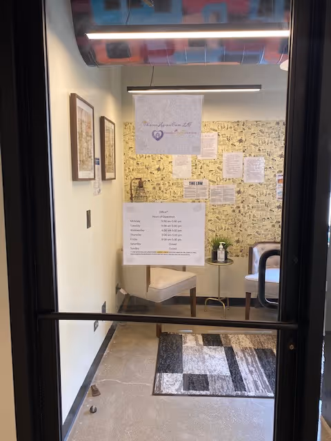 Interior hallway of a senior facility with chairs, posters, and bulletin boards.