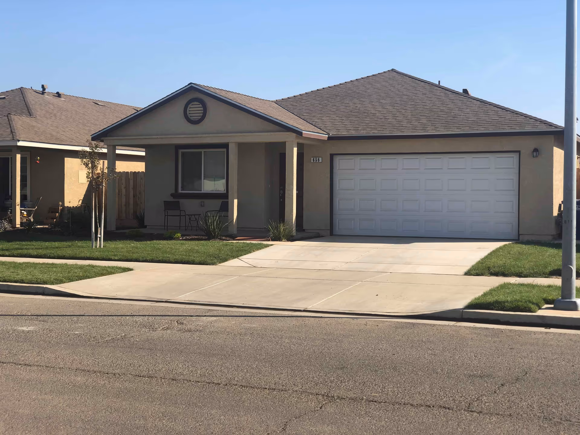 Front view of a single-story home with attached two-car garage and front porch.