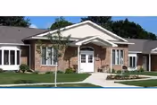 Brick senior living facility exterior with a white front door and walkway.