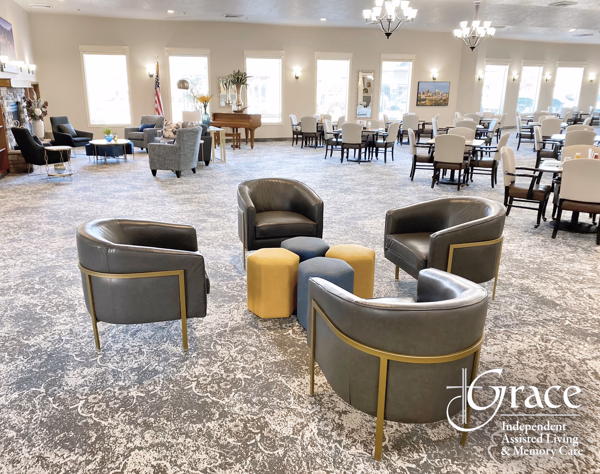 Spacious communal lounge with circular seating, tables, and soft lighting in Grace Assisted Living.