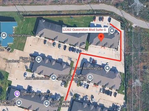 Aerial view of a senior facility complex with a red route line and parking areas.