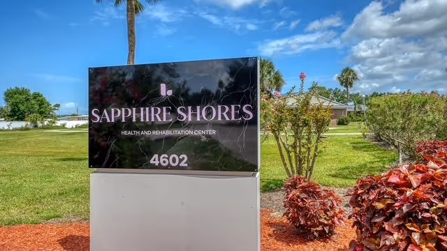 Outdoor sign for Sapphire Shores Health and Rehabilitation Center with landscaping.