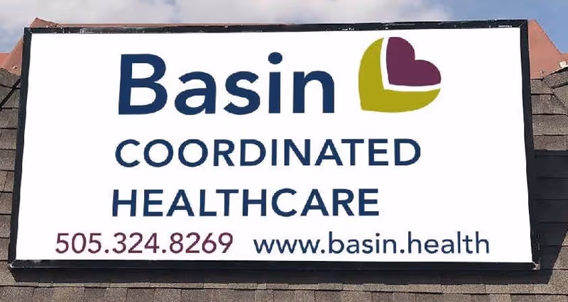 A building sign displays Basin Coordinated Healthcare with phone number and website.