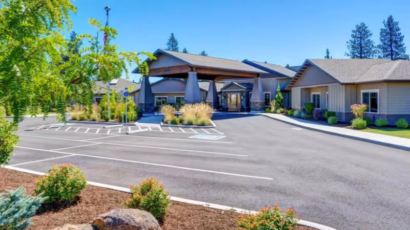 Exterior view of Mt. Bachelor Memory Care with entrance and parking lot.