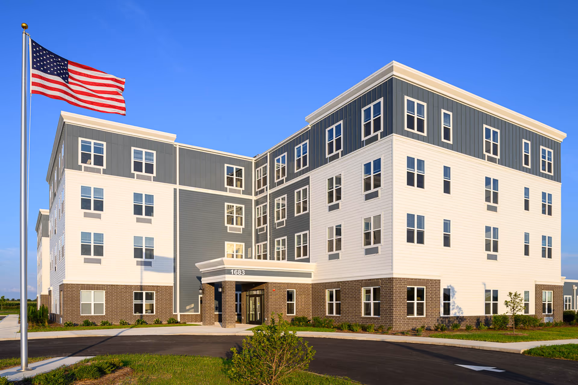 Exterior view of Vita Senior Living of Greenfield building with American flag
