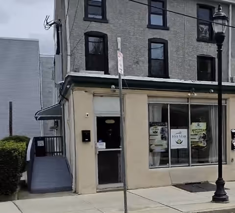 Exterior street view of a small beige storefront labeled Five Star Companion Care.