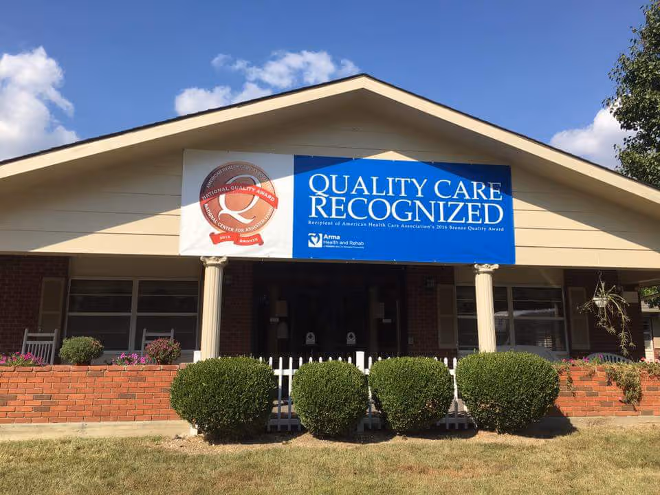 Front view of Arma Health and Rehab building with a Quality Care Recognized banner.