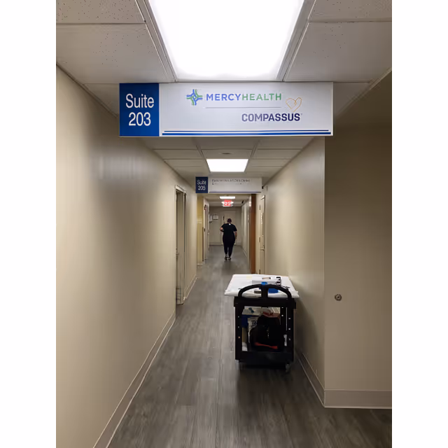 Long beige corridor in Mercy Health Home Care by Compassus with a cart.