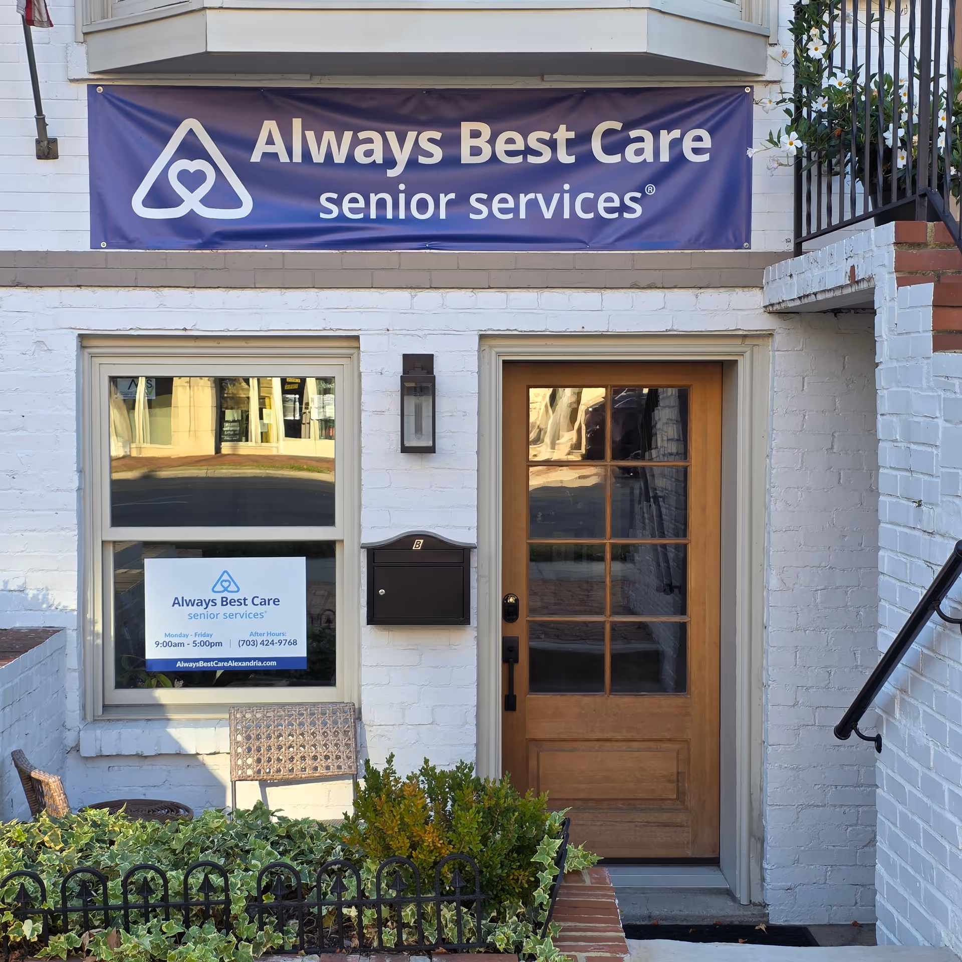Exterior of a building with an Always Best Care banner and wooden entrance door