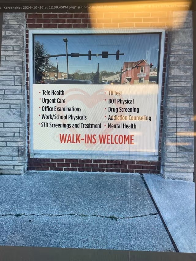 Exterior brick building with a large window sign listing health services and Walk-ins Welcome.