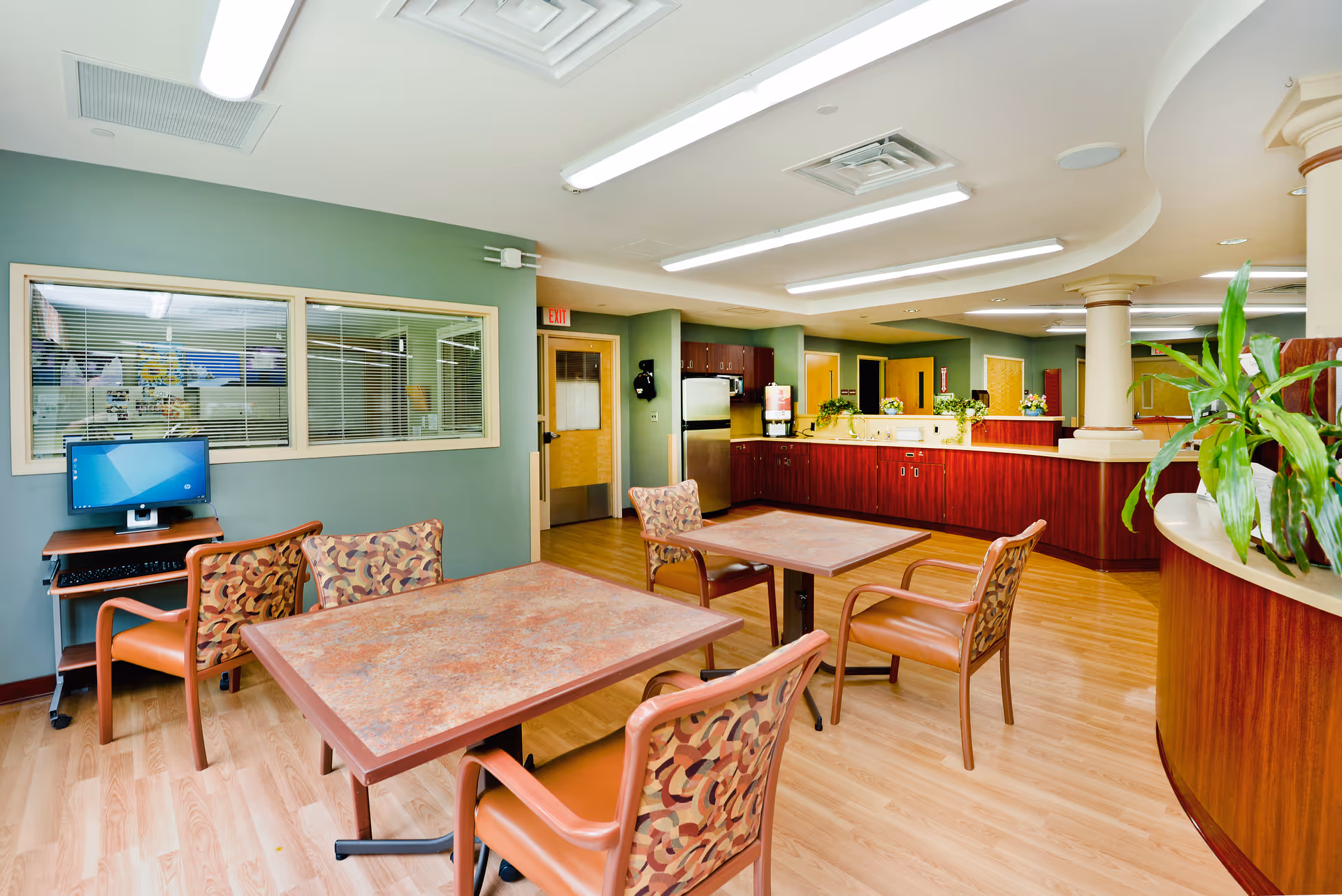 Interior dining area with tables, chairs, and a service counter.