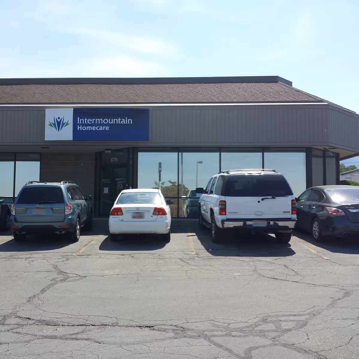 Front view of Intermountain Homecare & Hospice Ogden storefront with parked cars.