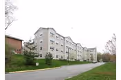 Exterior view of Luther Ridge at Middletown, a multi-story senior living building along a road.