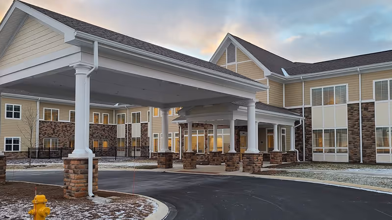 Exterior view of Centre Care facility featuring a covered entrance and stone columns.