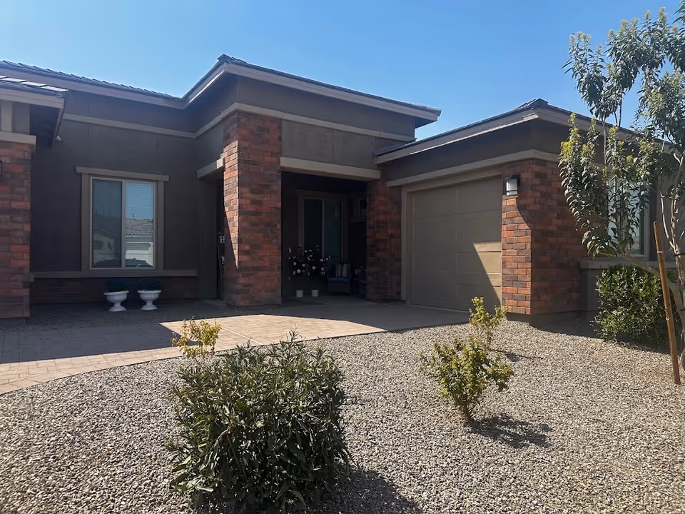 Front exterior of Harvest at Queen Creek Assisted Living entrance with brick columns.