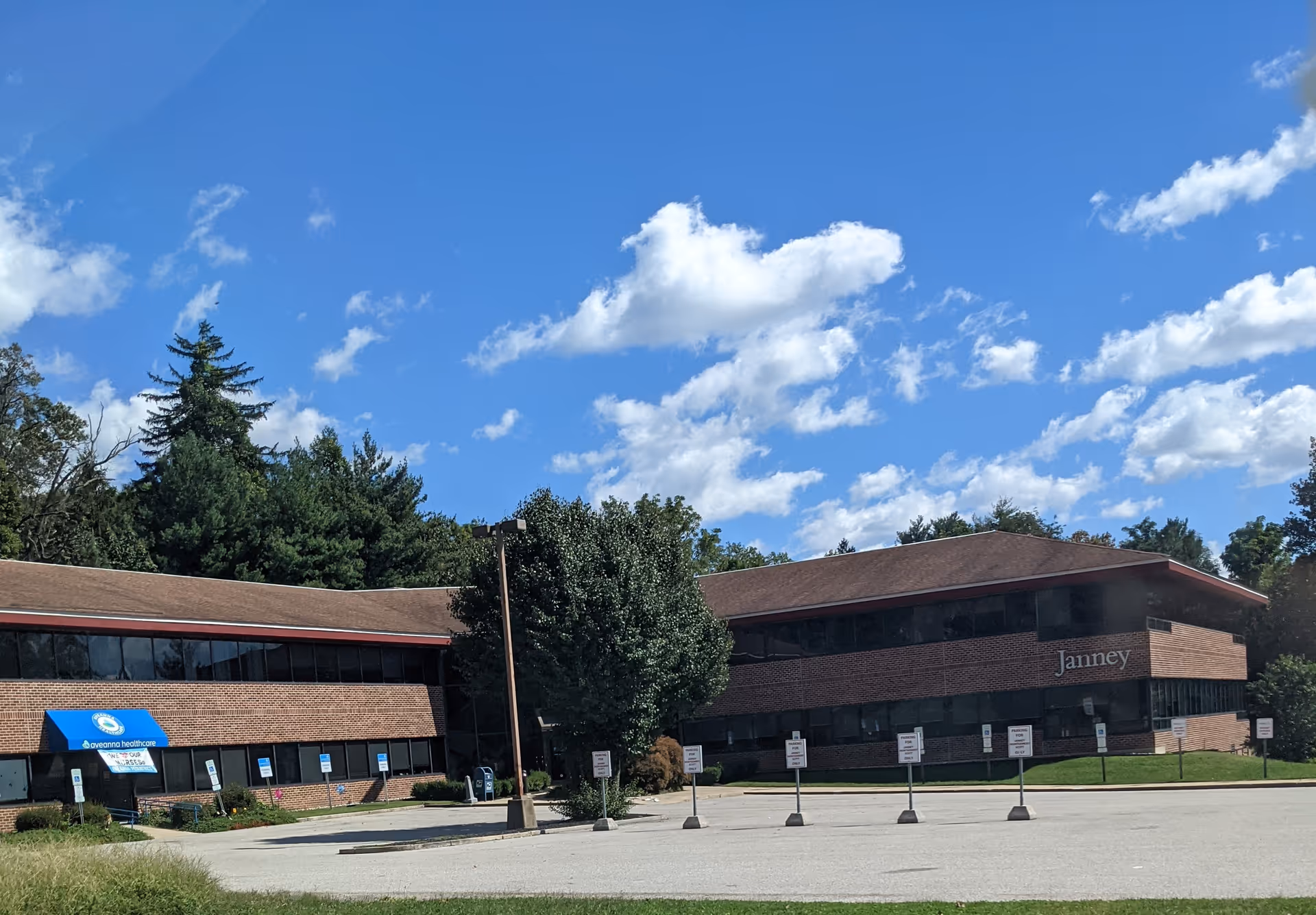 Exterior view of Comfort Plus Home Care, LLC building with brick facade and parking lot.