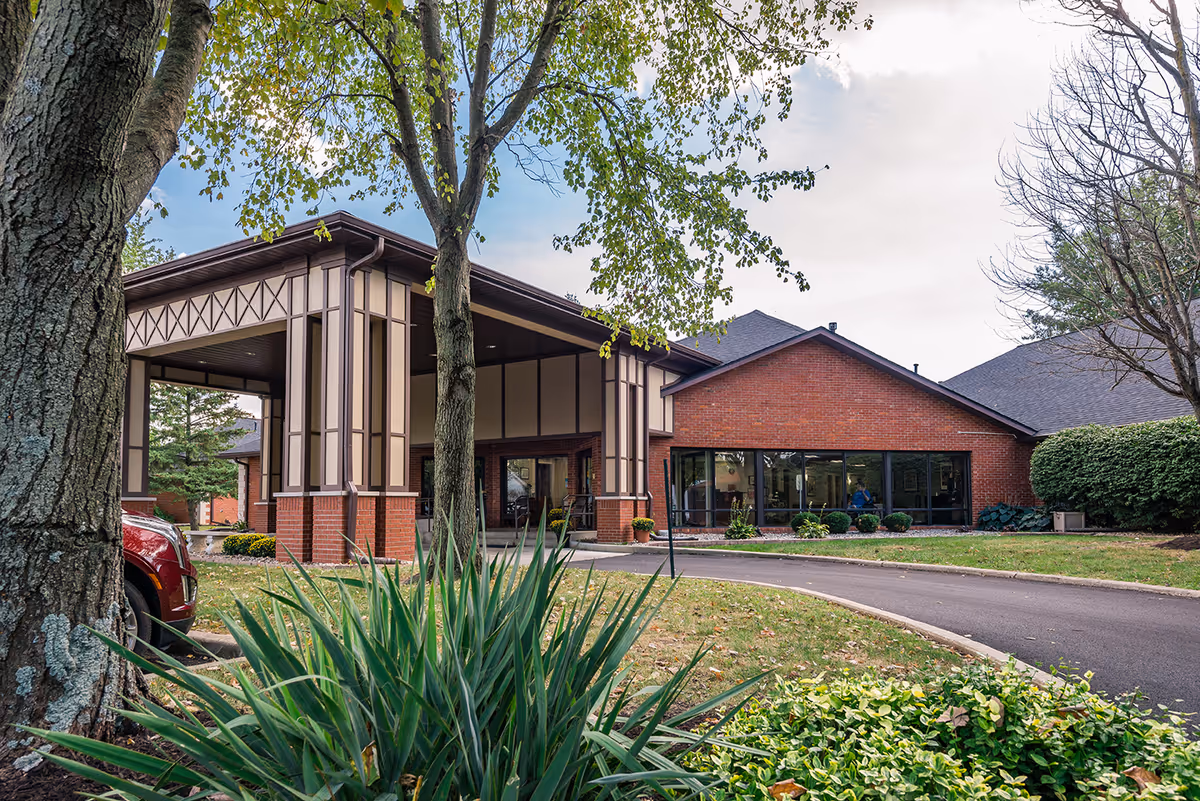Exterior view of Countryside Manor Health and Living Community entrance with brick building and landscaping.