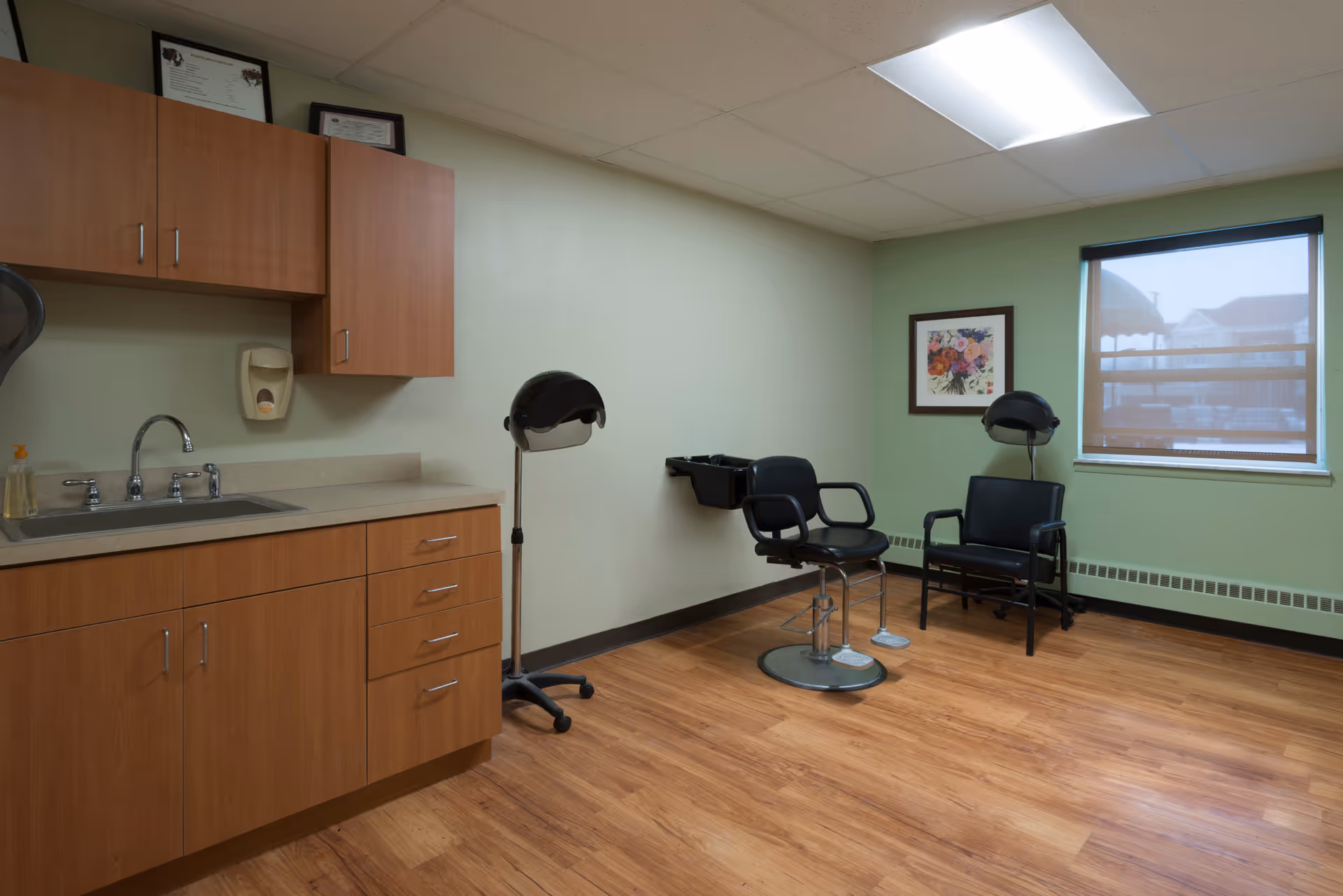 Senior living facility interior with kitchenette and a small hair salon area.