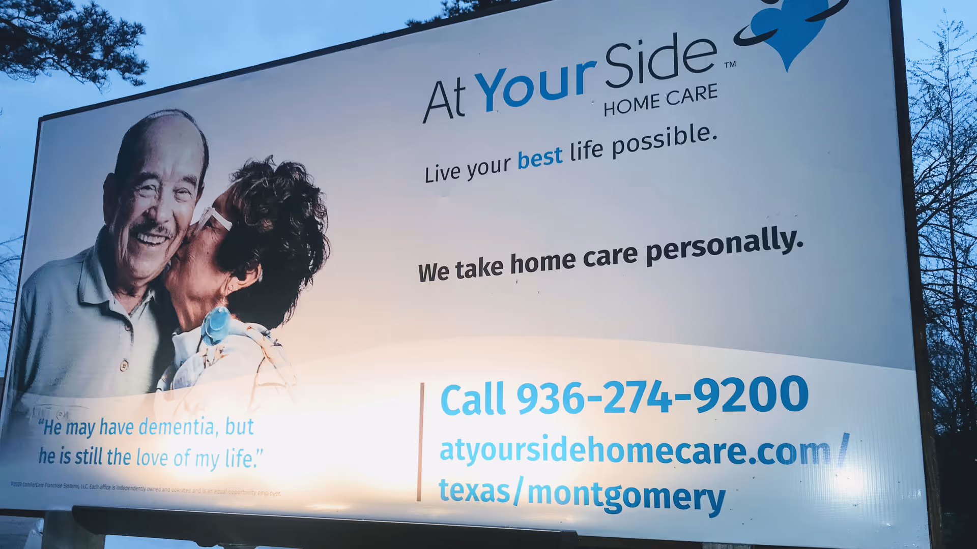 A large outdoor billboard for At Your Side Home Care Montgomery, featuring a smiling couple.