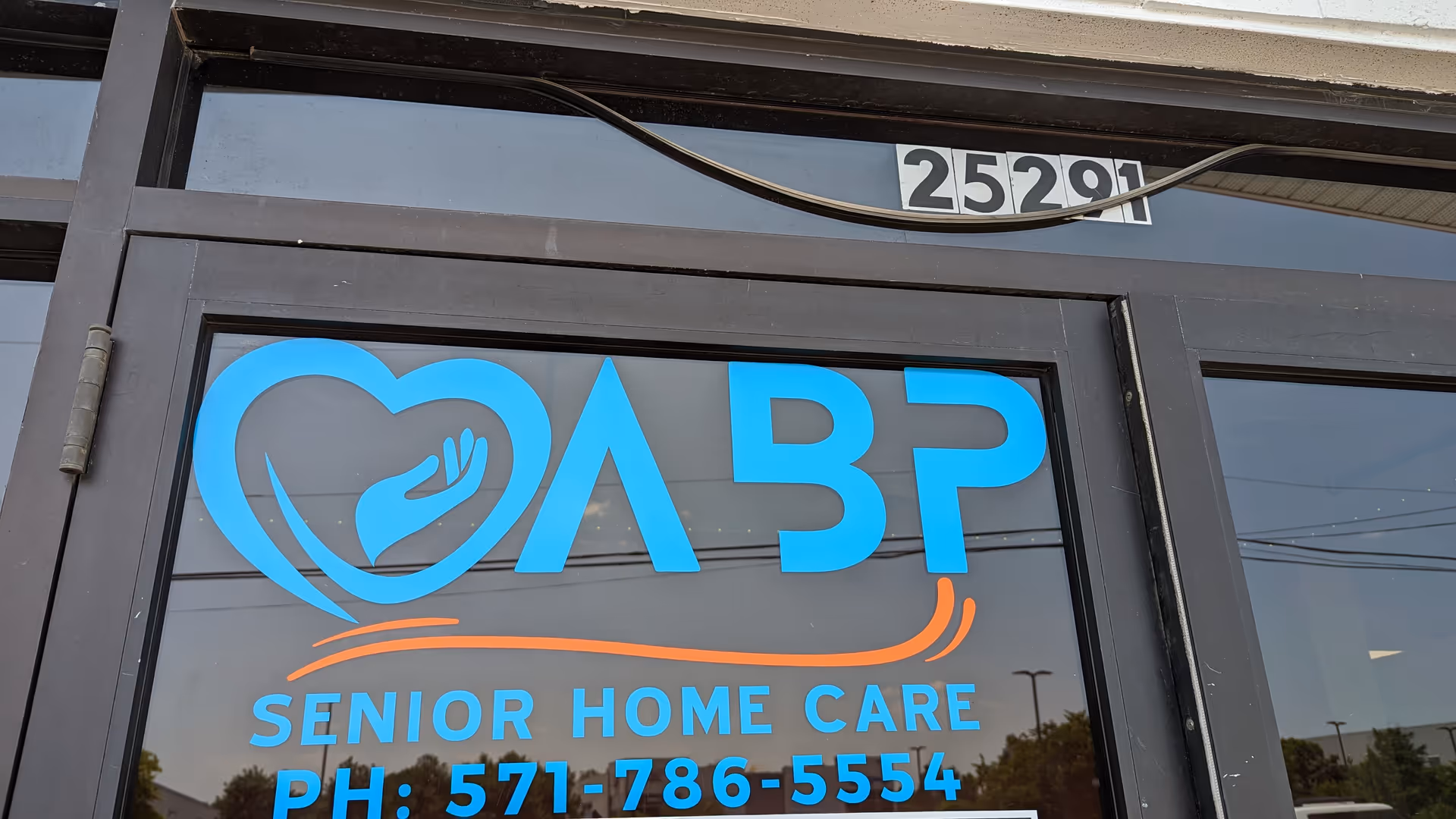 Front entrance of ABP Senior Home Care sign with logo and phone number.