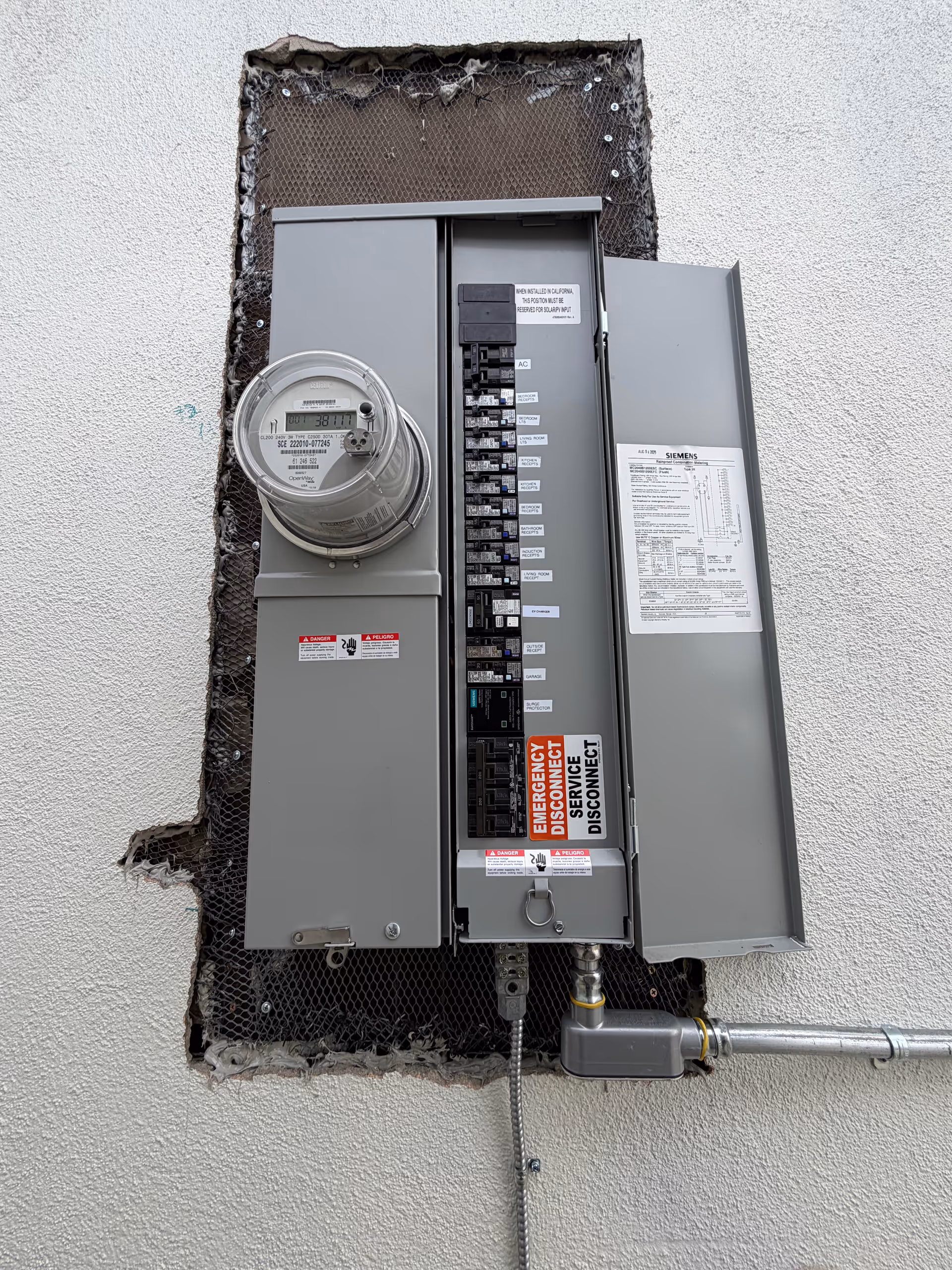 Close up of an exterior electrical meter panel mounted on a wall.