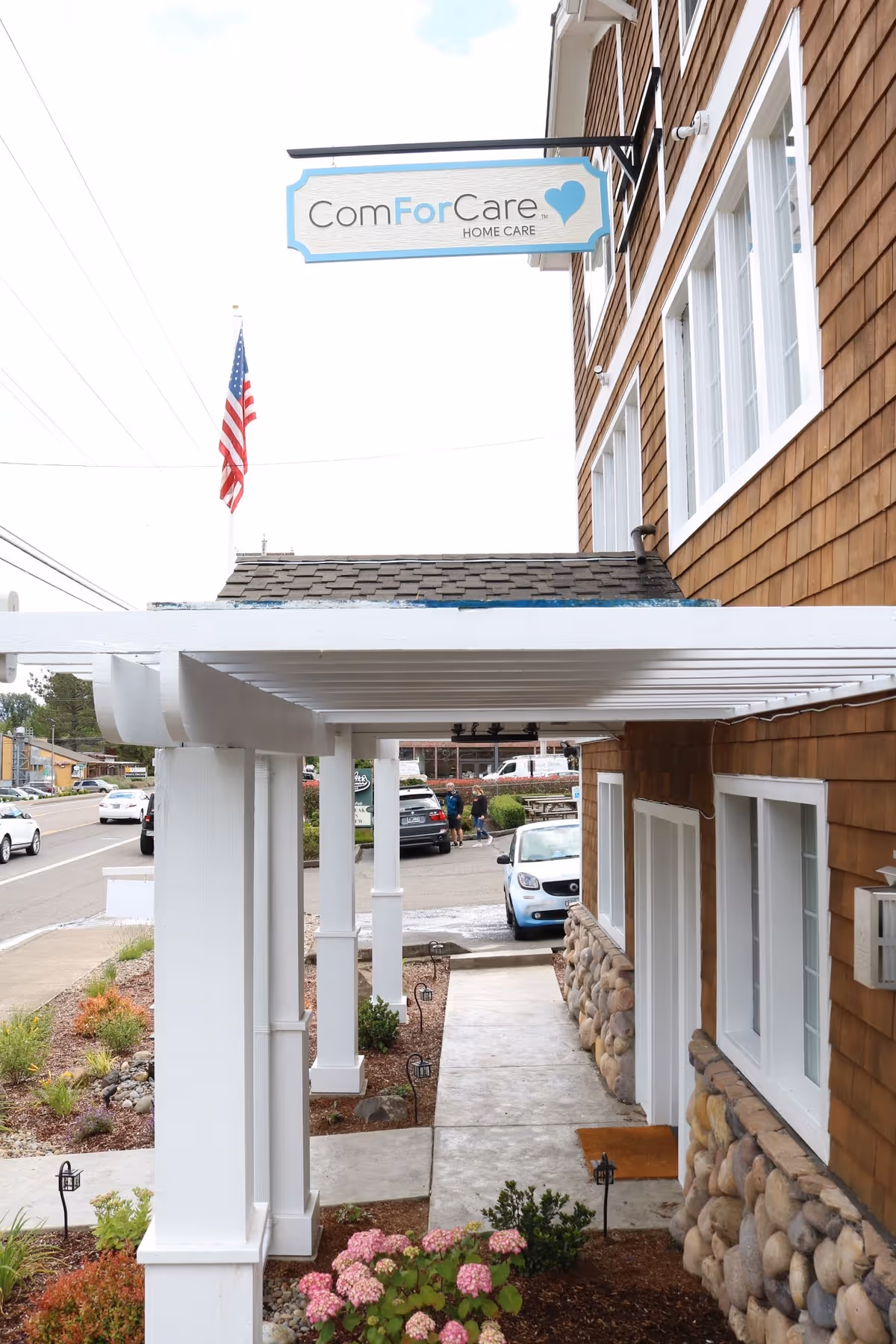 Exterior view of ComForCare Home Care building with sign, walkway, and landscaping.