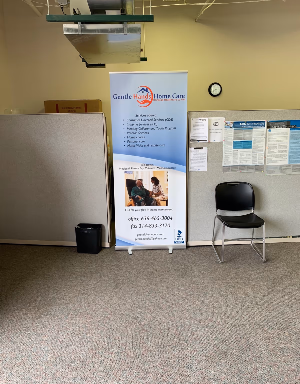 Interior area featuring a Gentle Hands Home Care banner and a black chair.