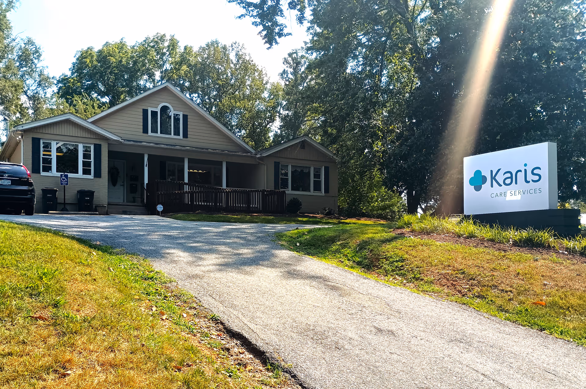 Exterior view of a beige senior living facility with a Karis Care Services sign.