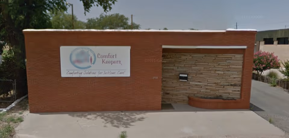 Brick exterior of a senior care facility front with Comfort Keepers signage.