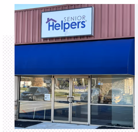 Exterior view of Senior Helpers Carlisle with a blue awning and glass doors.
