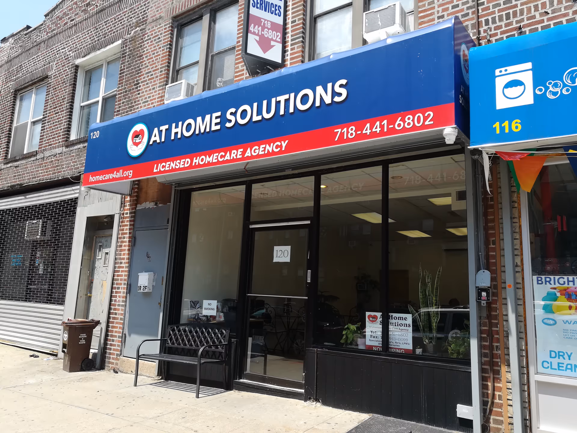 Storefront of At Home Solutions licensed home care agency on a brick building.