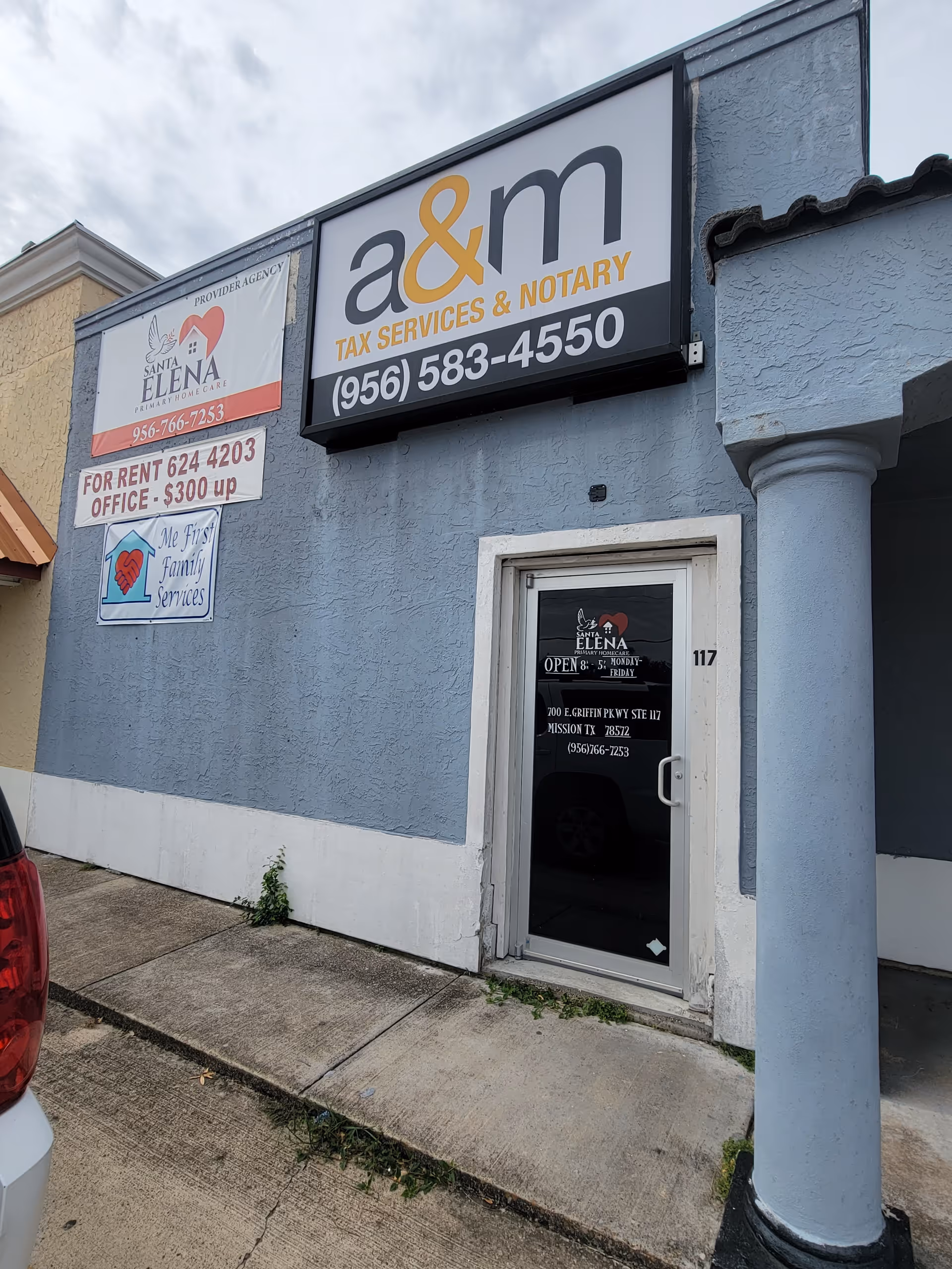 Blue storefront with Santa Elena Primary Homecare and a&m tax services signs.