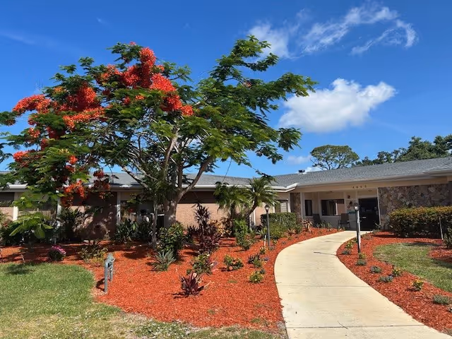 Sunny front view of Springwood Center with curved walkway and landscaped grounds