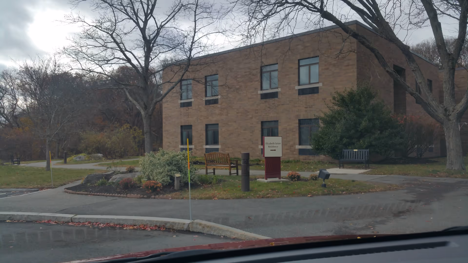 Exterior view of Elizabeth Seton Residence building with benches and landscaping