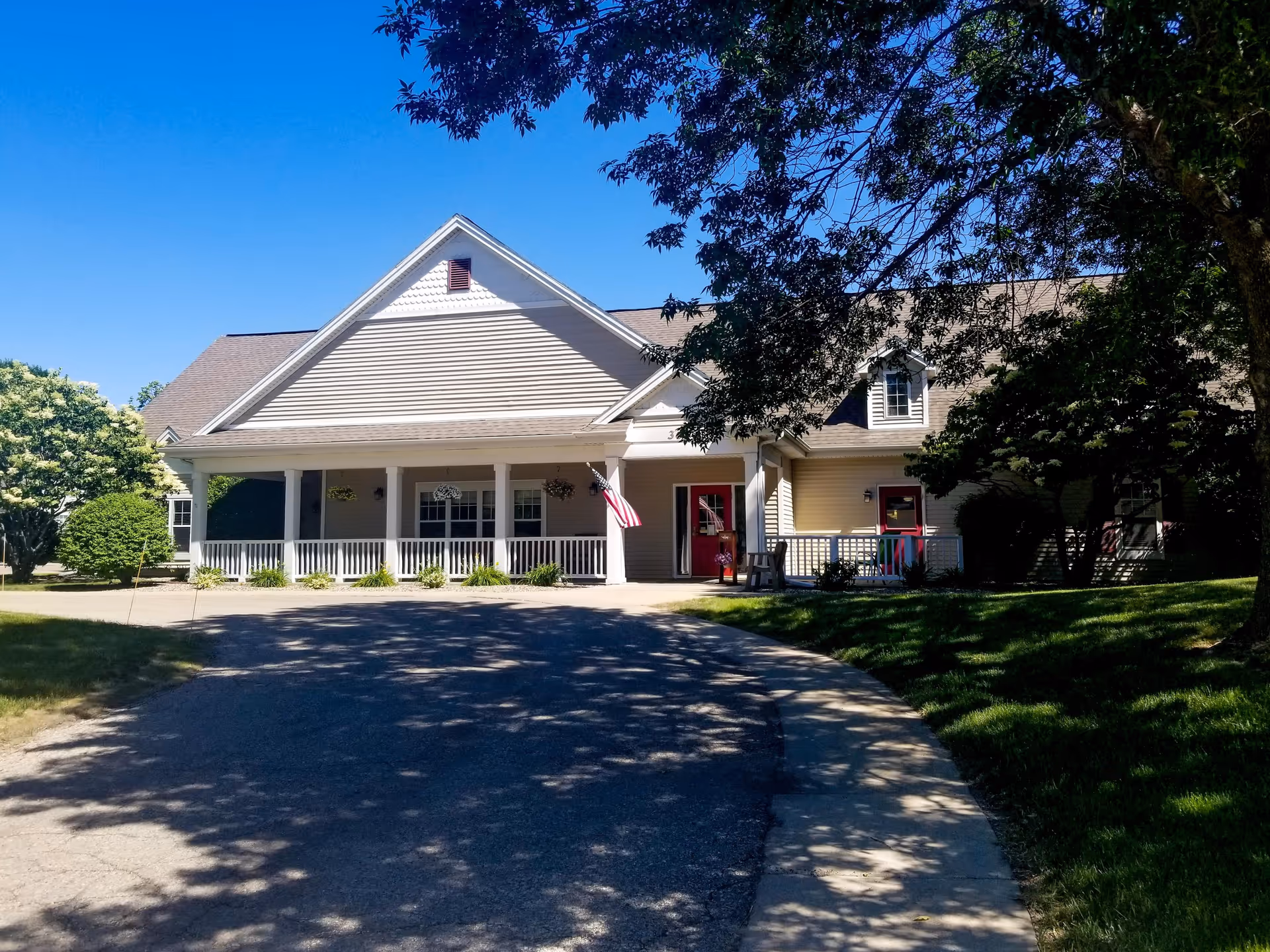Timberdale Trace Assisted Living front exterior with a covered porch and driveway.
