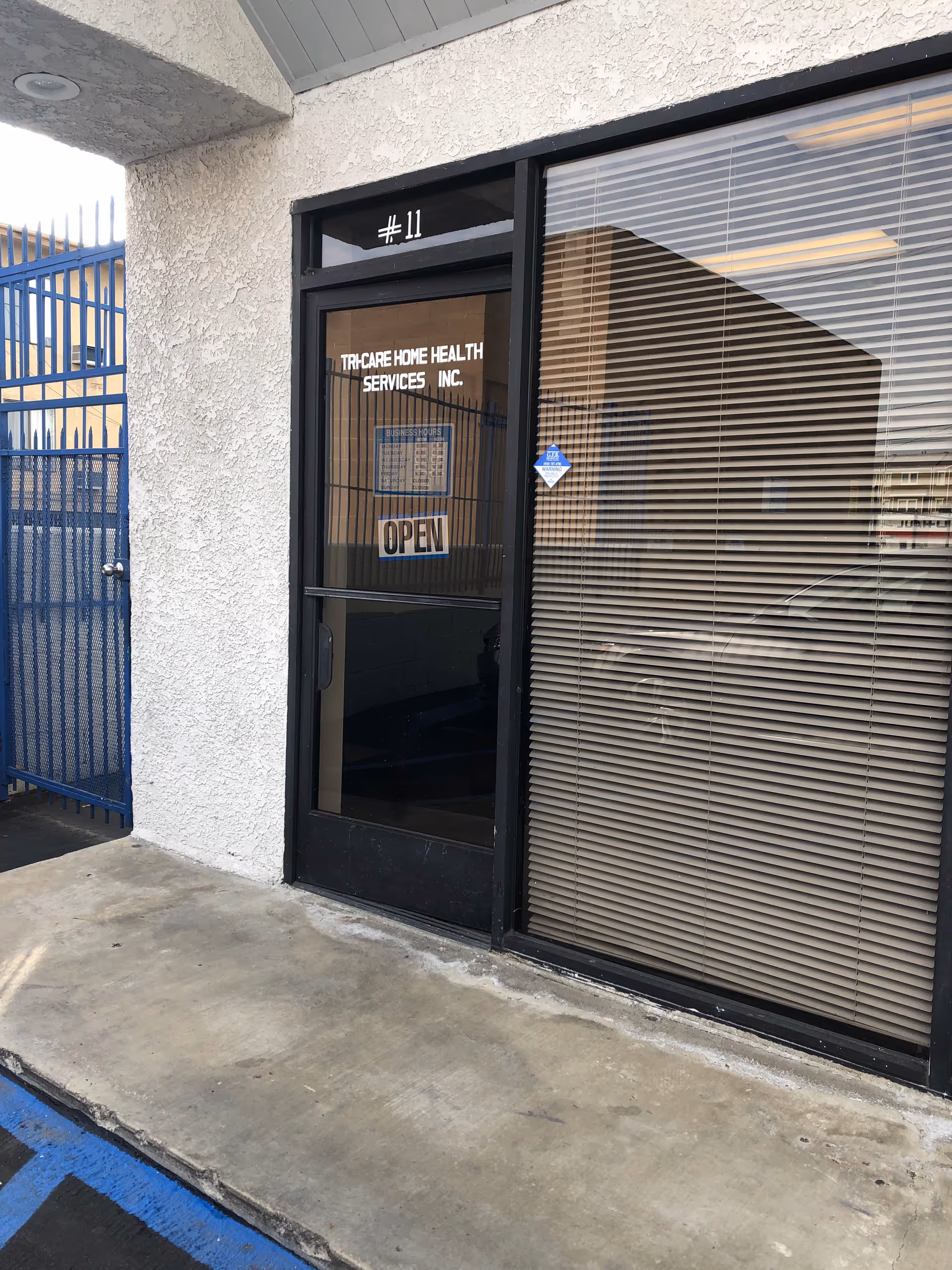 Exterior entrance to Tri Care Home Health Services Inc, glass door with blinds.