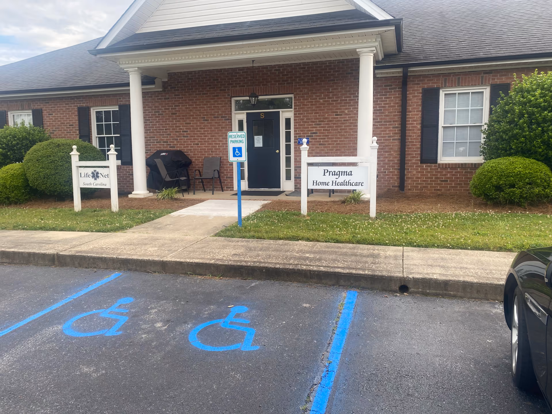 Brick facility exterior with a covered entrance and Pragma Home Healthcare sign.