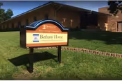 A Bethany Home Sioux Falls sign sits on grass in front of a brick building.