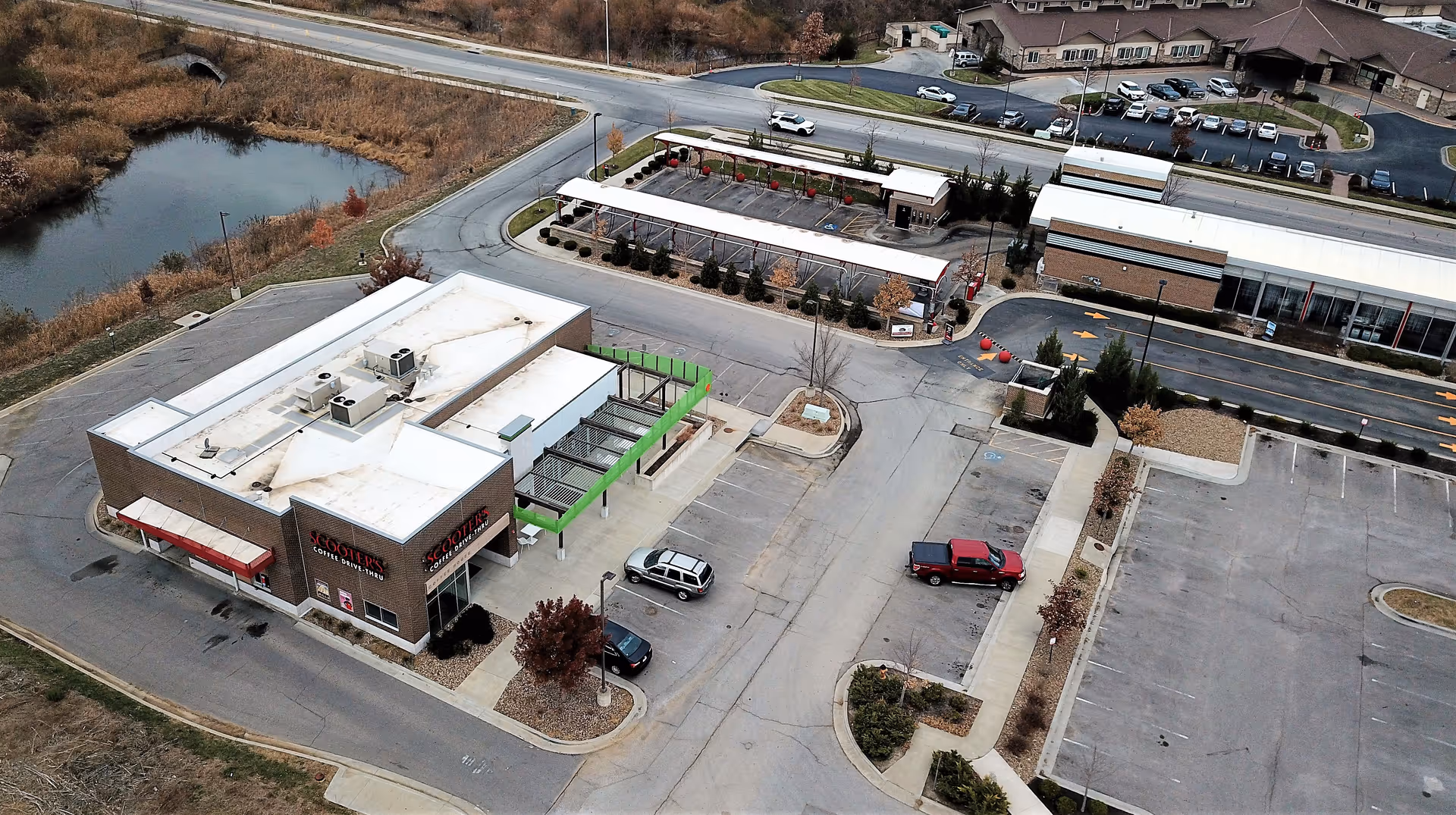 Aerial view of a single-story medical facility with parking lot and surrounding area.