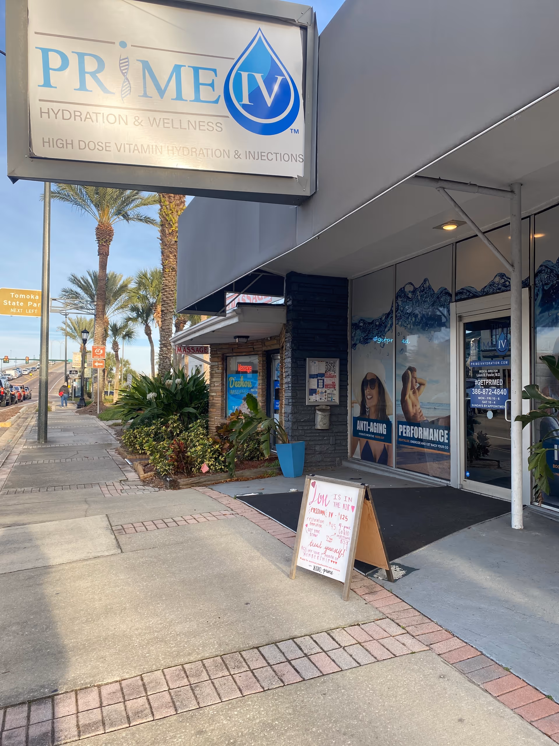 Exterior storefront of Prime IV Hydration and Wellness with signage and sidewalk display.
