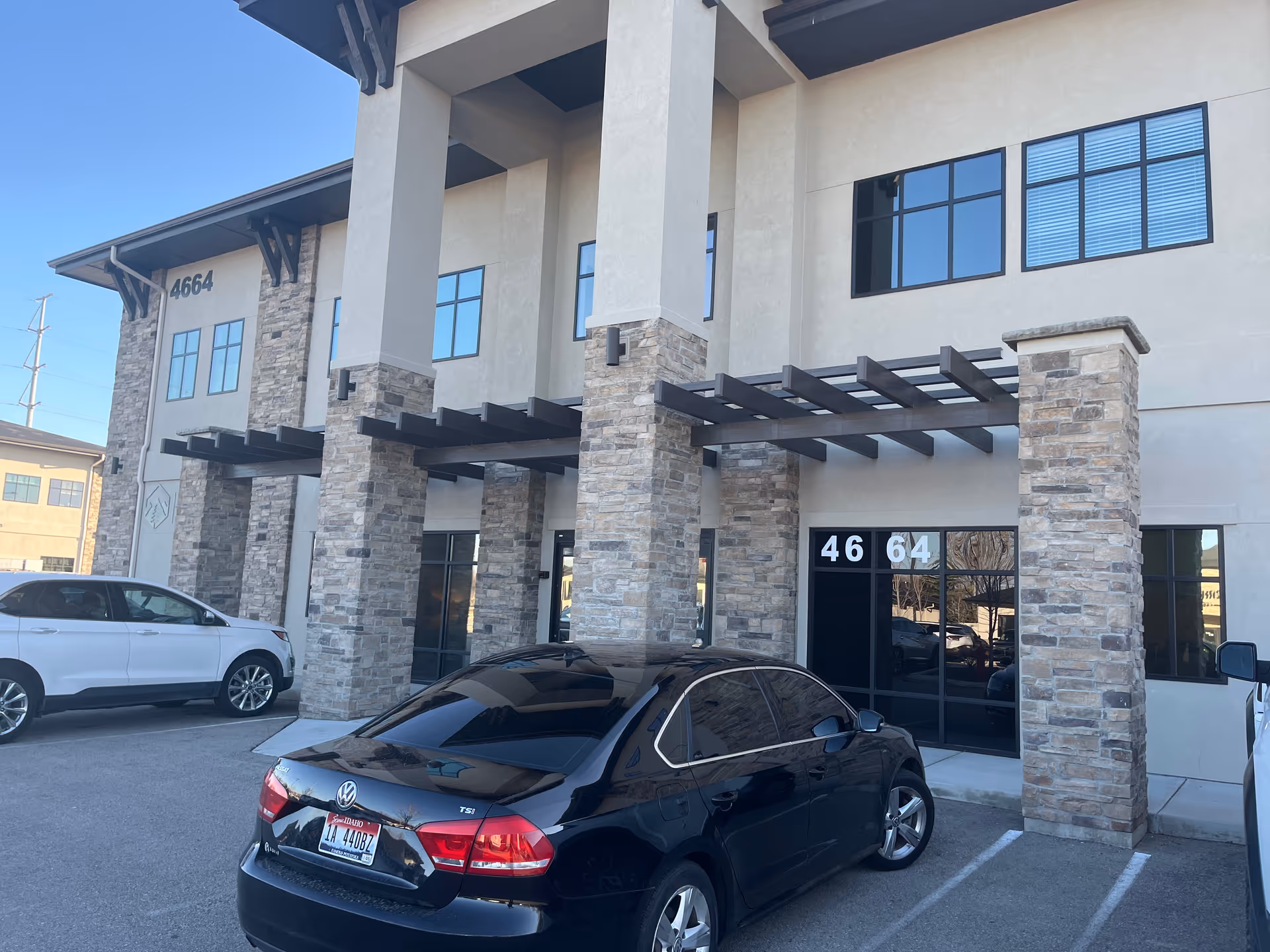 Exterior view of Canyon Home Care and Hospice building with stone columns and parked cars.