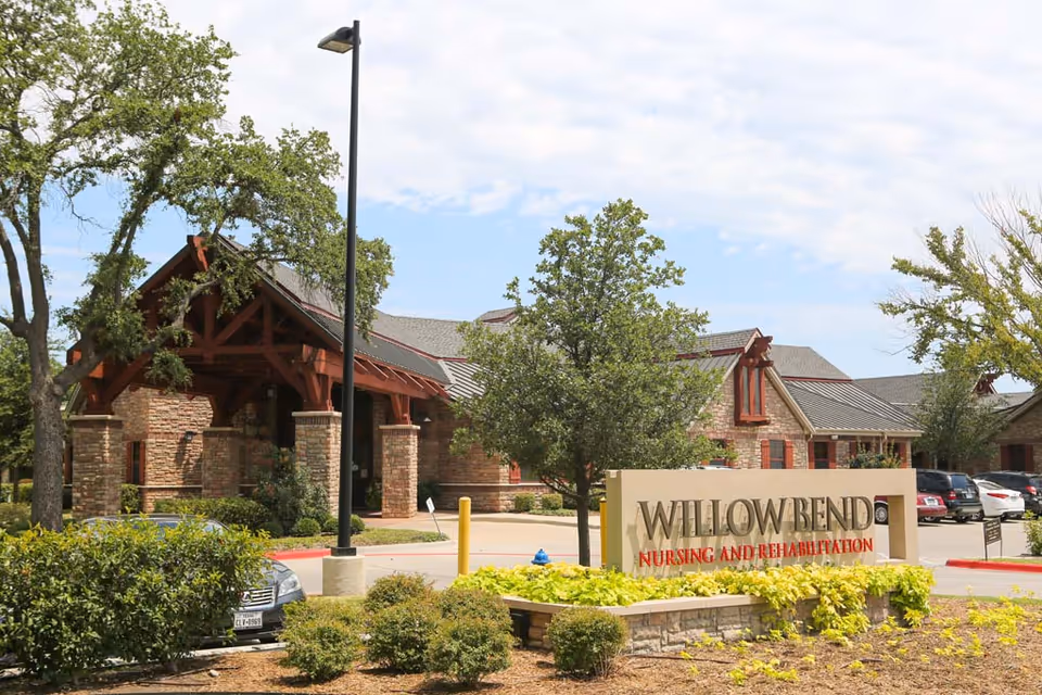 Exterior view of Willowbend Nursing & Rehabilitation Center with brick entrance and sign.