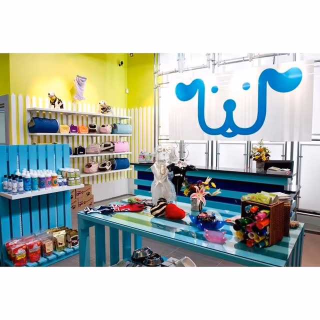 Bright interior shop at Comfort & Joy Care LLC with shelves and a blue logo banner