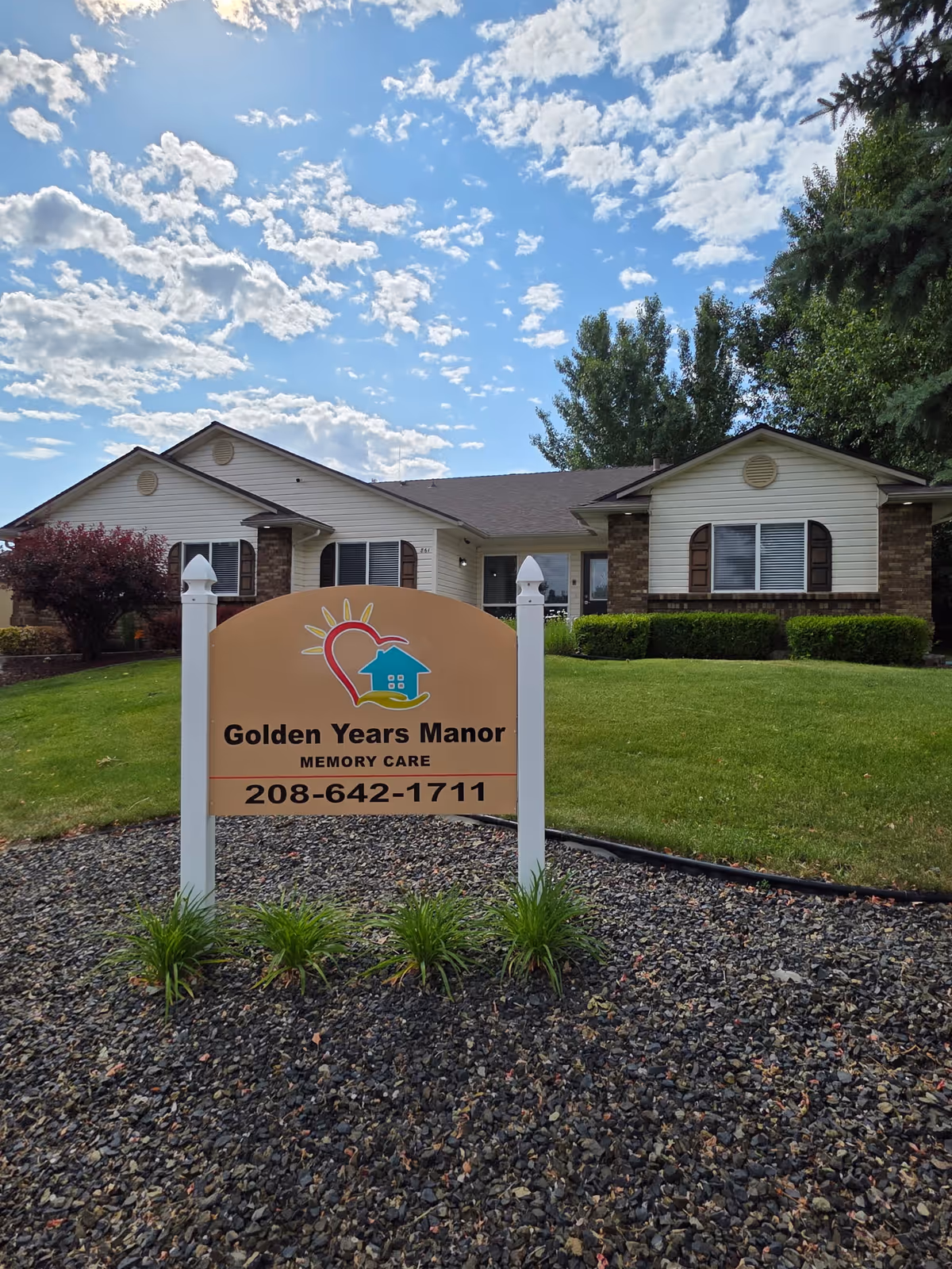 Exterior of a single-story memory care facility with a sign for Golden Years Manor.
