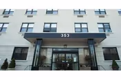 Front entrance of Rockaway Care Center, a multi-story building with glass doors and a canopy.