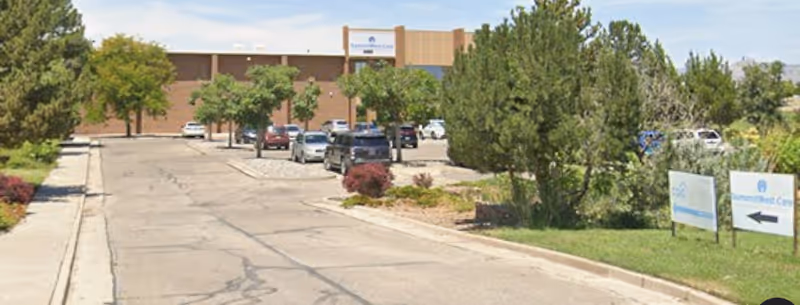 Exterior view of SummitWest Care building with trees, parking lot, and signage