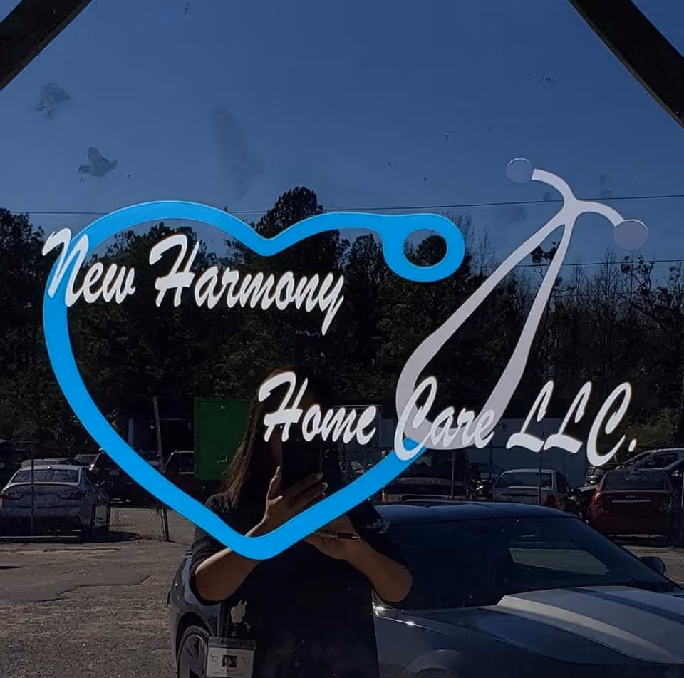 Glass window sign reads New Harmony Home Care LLC with a heart-stethoscope logo.
