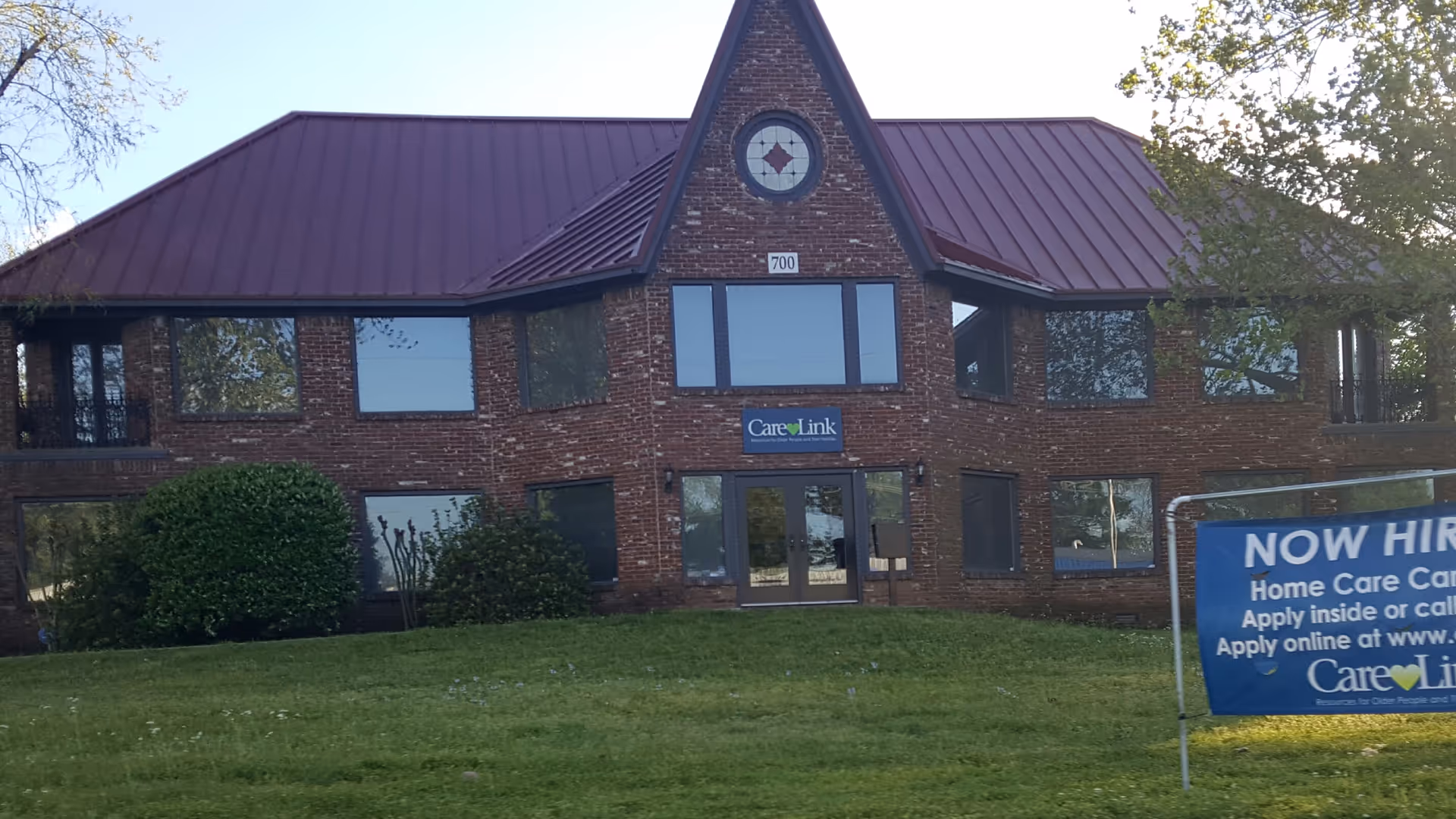Brick CareLink senior living building with large windows and front entrance.